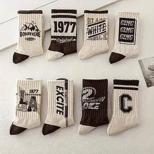 10 pairs of men's classic throwback socks fashionable accessory with typography designs muted color palette secure performance fit great for basketball training and outdoor games tough knitted construction