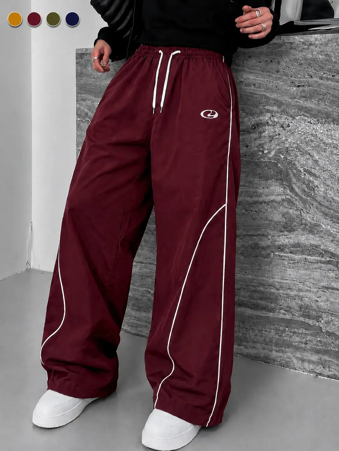 Men’s burgundy wide-leg athletic pants featuring curved white lines, Y2K retro print, drawstring design, casual style; American street-style color-block sportswear made from lightweight fabric for spring/summer—breathable and comfortable, classic design.