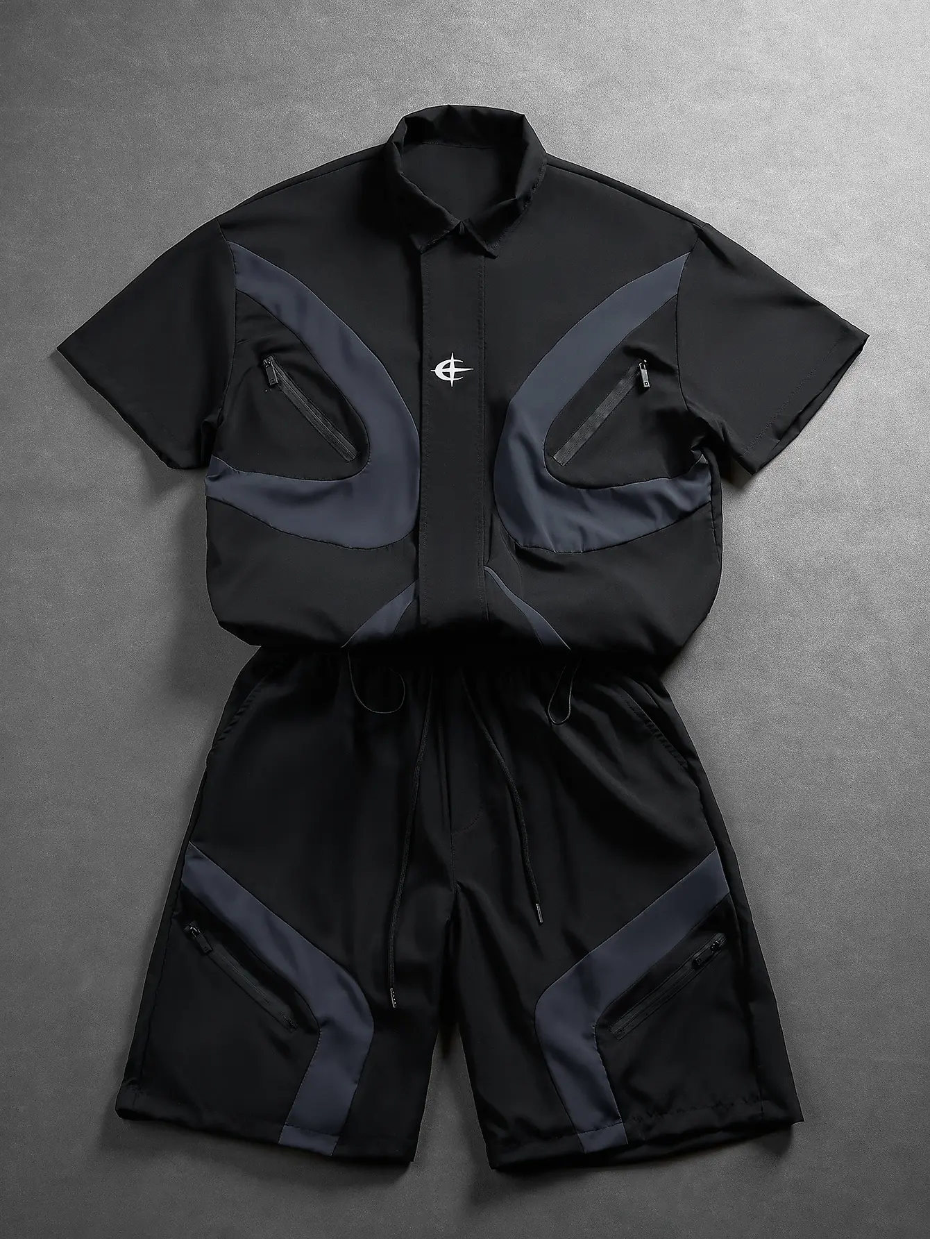 Unisex techwear colorblock short sleeve shirt and shorts 2 piece set — arc contrast panels, abstract chest print, waterproof zip pockets, elastic drawstring quick dry shorts; summer high street skater and street style outfit