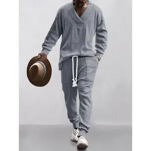 Men’s two-piece set featuring a solid jacquard pattern: drop-shoulder V-neck top and drawstring-waist pants. Suitable for autumn and winter outfits.
