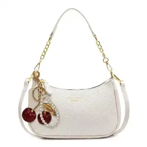 Woven texture crescent underarm bag, crossbody bag with an elegant cherry pendant, fashionable Hobo handbag, refined small women’s shoulder bag, crossbody bag with a chain strap, lightweight compact women’s small work bag, suitable for everyday use and as
