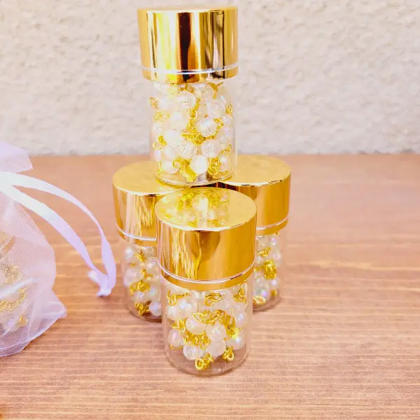 Rosary in a glass bottle with gold top, religious gifts