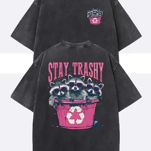 Unisex Stay Trashy Graphic Tee -  Heavyweight Washed Black Tee with Pink Raccoon & Bin Design, Relaxed Fit Crew Neck for Summer Festivals, Beach Trips & Ironic Gifts | Eco-Conscious Humor Casual Stylish