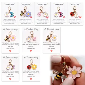 A set of 10 Pocket Hugs keychains, each with an accompanying motivational card, a sentimental keepsake, a suitable graduation gift, providing positive emotional support for friends and children, and encouraging them in various situations.