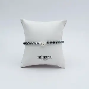 950 Silver Chaquira bracelet with 4mm hematite beads and silver beads, featuring a mother-of-pearl initial. Crafted in 950 sterling silver.