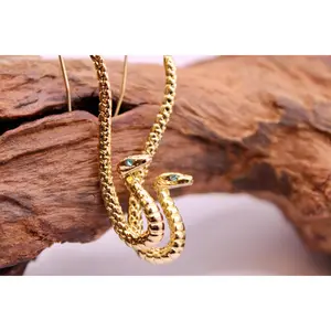 Gold Serpent Earrings – Striking Snake Jewelry with Piercing Blue Eyes