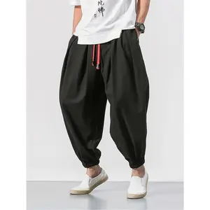 Men’s harem pants with pockets and a drawstring waist, comfortable for everyday outdoor wear; woven bottoms suitable for spring and autumn.