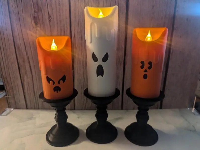 Three eerie Halloween LED candles with ghostly faces that are 3D printed Three eerie Halloween LED candles with ghostly faces that are 3D printed