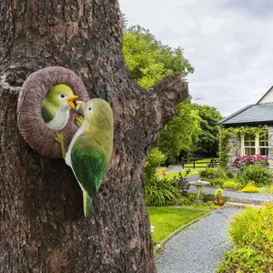 A simulated feeding resin handicraft bird-feeding pendant, which can be used for tree decoration, gardens, courtyards, lawns, porches, balconies, home decoration, furniture, tabletops, living room wall decoration, and outdoor courtyard tree hanging