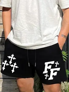 A pair of black men's Fitted Essential shorts, suitable for casual outdoor wear, featuring a cross and letter pattern.