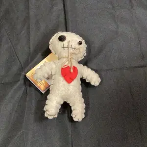 Doll with Red Heart Charm and Unique Stitched Design for Collectors