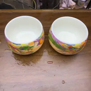 Building a teacup with white hand-painted dragon and phoenix pairs