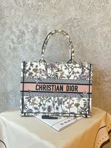 Pre-owned Dior Medium Book Tote from the coveted Florilegio collection, features intricate floral & insect embroidery on white canvas 1919H0553