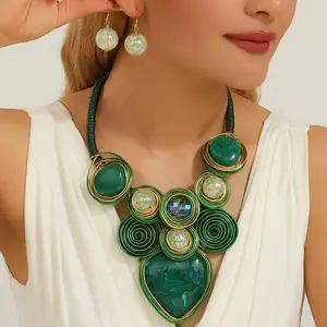Bold emerald green statement necklace earrings set, gold wire-wrapped chunky pendant accessories, vibrant boho-style pieces for women, standout gift for fashion lovers