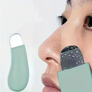 Gentle cleansing tool for manual removal of blackheads and acne, non-electric skincare brush with an easy-to-hold mint green handle, suitable as a gentle facial pore cleanser for blackheads.