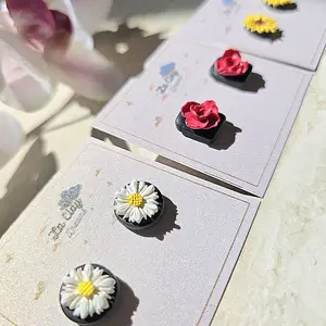 La Clay Dreams Flower Studs Polymerclay Earrings on Black Background Red Rose White Daisy Yellow Sunflower Variations
