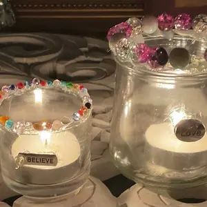 Handmade , delicate beaded tealight holder .