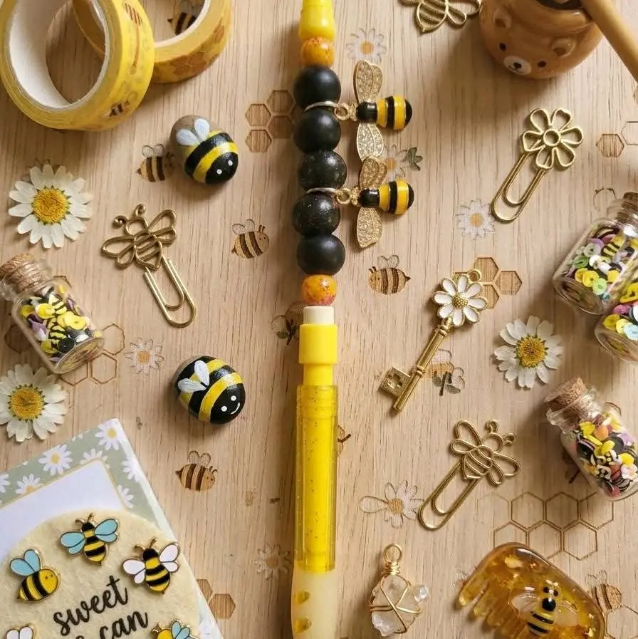 yellow mechanical pencil with black beads and bumblebee charms
