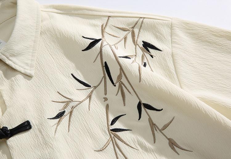 New Chinese-style long-sleeve top featuring bamboo leaf embroidery, a loose fit, frog buttons, design-forward retro high-end feel, and a drapey silhouette—a relaxed casual top with premium quality.