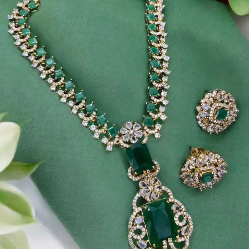 Victorian-style necklace and earring set with emerald green stones and cubic zirconia