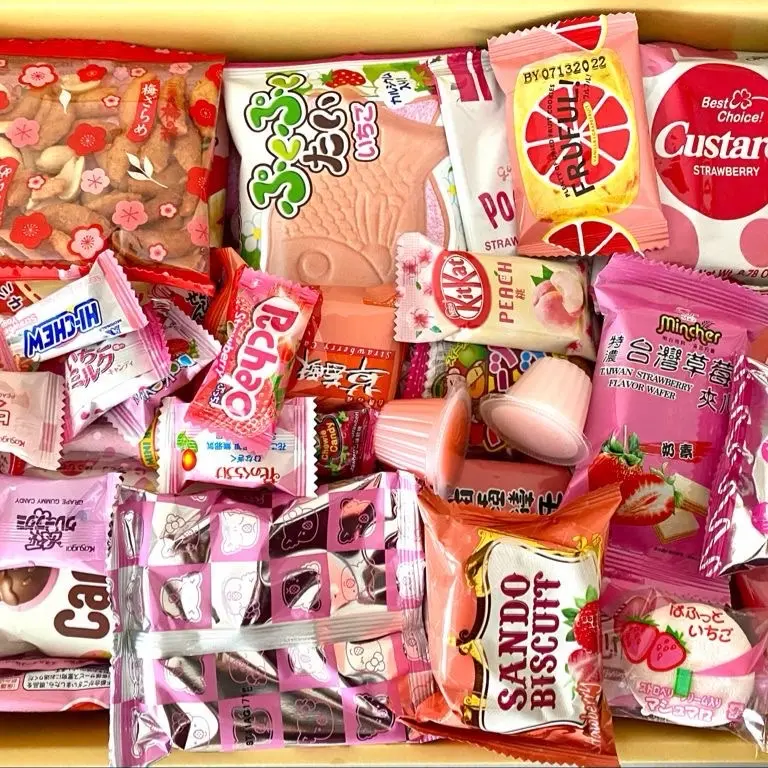 Pink/Red Asian Snack Box with Ramen Drinks Includes Various Candy and Snacks Featuring Strawberry Flavors Sweet Dessert Macarons