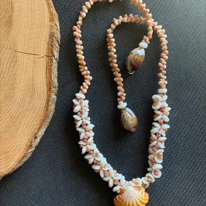 Hand crafted Puka Kahe shell lei plumeria style with sunrise