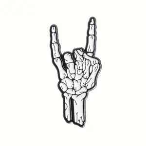 Rock and roll skeleton hand enamel pin