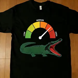 Crocodile Print T-Shirt — Featuring a graphic of an extremely hungry crocodile, this cute, retro-style top offers a fashionable, unisex, and casual aesthetic. A humorous statement piece with a whimsical animal motif, it embodies high-street trendiness and