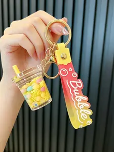 A keychain pendant in the shape of a milk tea cup with flowing oil sand simulation, suitable for daily wear, vacations, dates, and other occasions, and also a delightful and exquisite small gift.