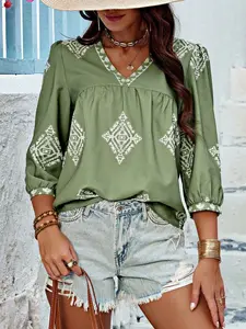 A women's geometric print V-neck, three-quarter sleeve loose-fitting shirt blouse with a beachy, Elegant vibe that flatters the figure and is versatile.