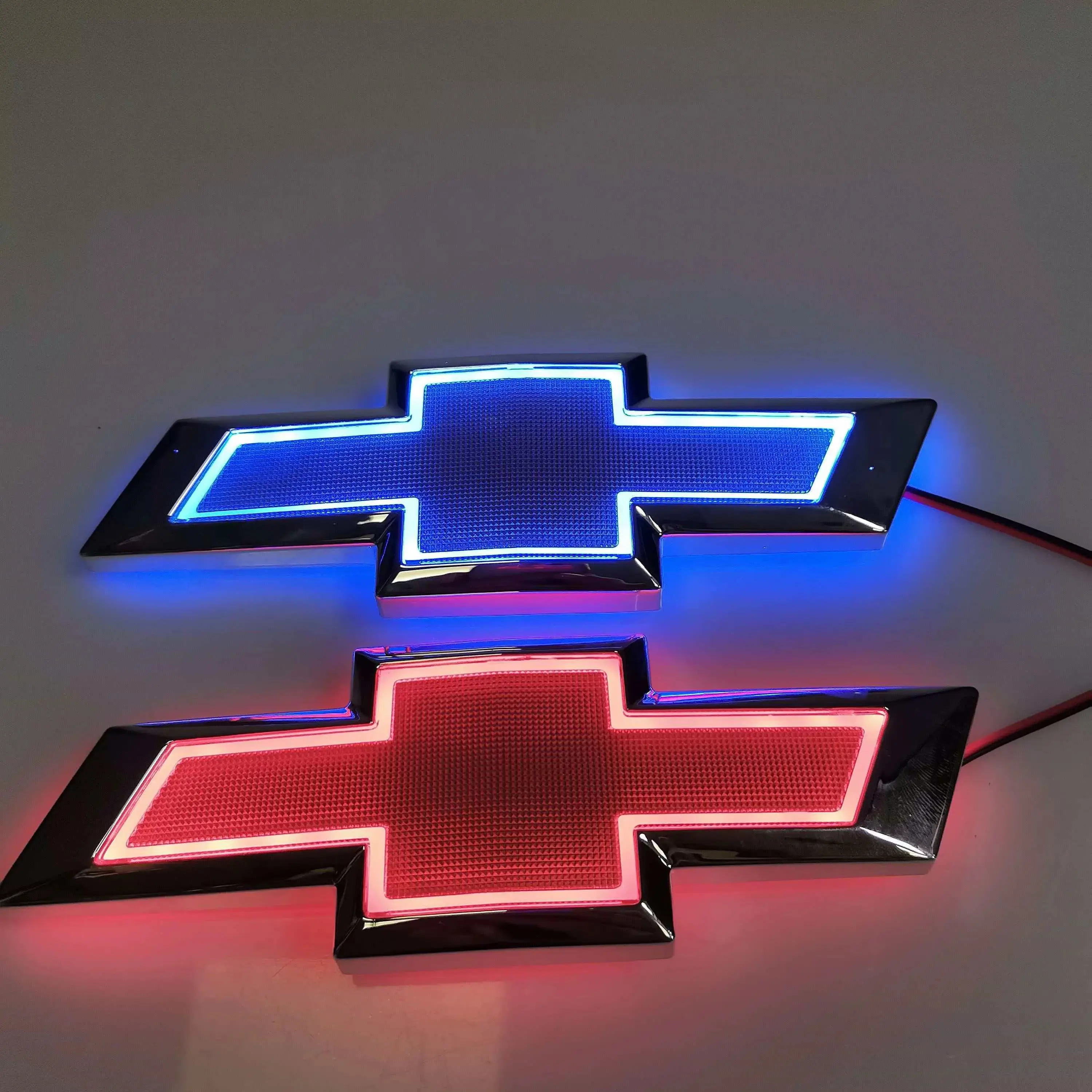 5D LED illuminated bowtie emblem for Chevrolet, multi-color illuminated badge in red, blue, and white with chrome trim, waterproof direct-replacement exterior accessory for front grille and tailgate.