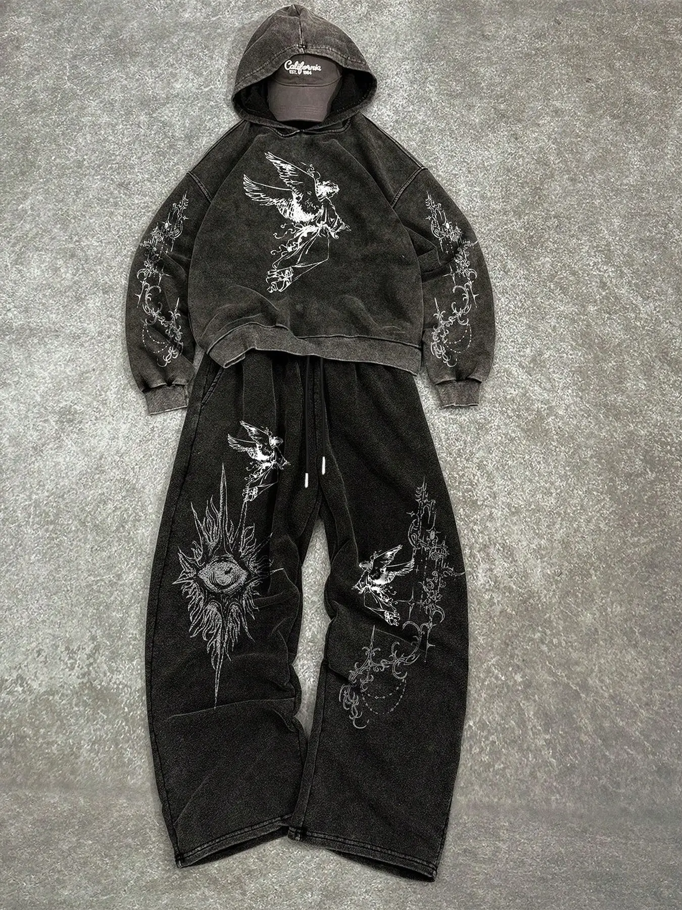 Men's Acid Wash Oversized Long Sleeve Hoodie Set with Fallen Angel Print, Dark Opium Aesthetic Casual Two-Piece Tracksuit Outfit, Gothic Evil Eye Graphic Heavyweight Fleece Sweatshirt and Baggy Joggers for Streetwear Enthusiasts.
