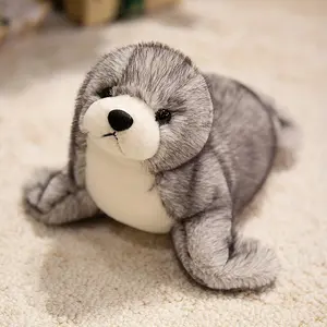Adorable plush sea lion toy, super soft stuffed animal in a lazy pose, with silky fins suitable for cuddling and sensory play in the nursery