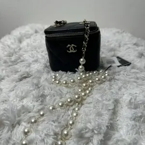 Pre-owned CHANEL LambSkin Travel Bags quilted mini vanity case with a pearl chain strap