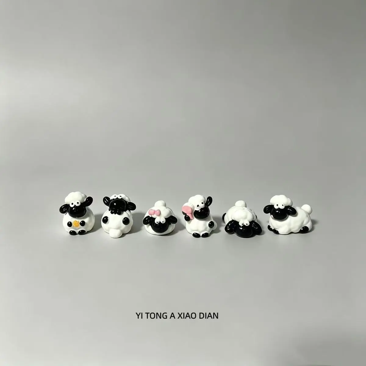 Mini desk figurines with cute sheep character designs to refresh dull workspace decor, smooth waterproof solid resin in black and white base with soft pink & yellow tiny accents, compact lightweight build