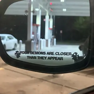 A vinyl sticker decal with the words "Your demons are closer than you think", removable, suitable for car mirrors, perfect for Halloween decorations and a humorous car decal.