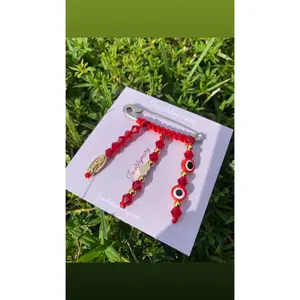 Red pregnancy brooch