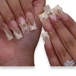 Elegant Floral Nail Art with Gold Accents and Glitter for a Chic Look