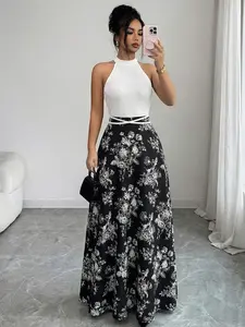 A classic Chic long dress with black-and-white patchwork and floral prints, featuring a halter neck, waist cinching and a full flared skirt. Suitable for weddings, dinners, parties, dates and daily outings.