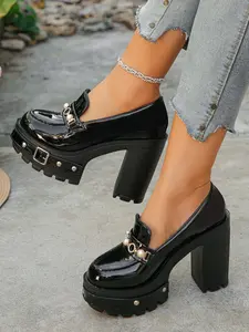 A pair of Women's Platform Block Heel Loafers, Patent Leather Upper, Chunky Studded Lug Sole, Pearl Buckle Accent, Edgy Platform Shoes, High Heel Loafers for Parties, Night Out, Street Style, Bold Footwear, Slip-On Design, Trendy Heeled Loafers, Elegant