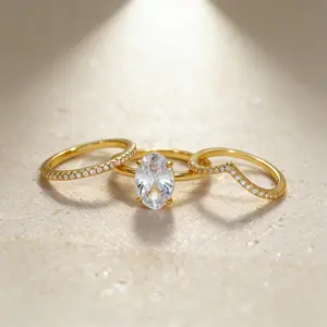 An elegant, affordable three-piece ring set featuring a center ring with a four-prong setting showcasing an oval-shaped synthetic zirconia. This classic design is perfect for stacking and makes an ideal engagement or bridal ring—the perfect gift for her.