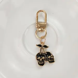 1/20pcs Gothic Cherry Skull Keychain – Golden-Tone Zinc Alloy Pendant with Black Enamel Skulls & Cherry Design, Edgy Men’s Car Key Accessory, Unique Backpack Charm, Creative Fashion Gift for Halloween or Birthdays, Bag Accessory, Lightweight Keychain