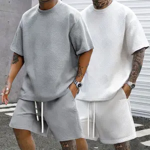 Two  of men’s casual fashion trend outfits featuring heavyweight textured fabric—minimalist textured short-sleeve T-shirts paired with shorts—showcasing a unique street style and comfortable living; ideal as holiday gifts. men 2 piece sets