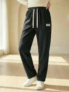 Women's casual solid color corduroy trousers, loose straight leg style, elastic waistband with drawstring, delicate stripes, front and back pockets, suitable for home and casual outings in spring and autumn.