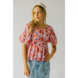 The Kinsella Floral Peplum Blouse in Peach Multi