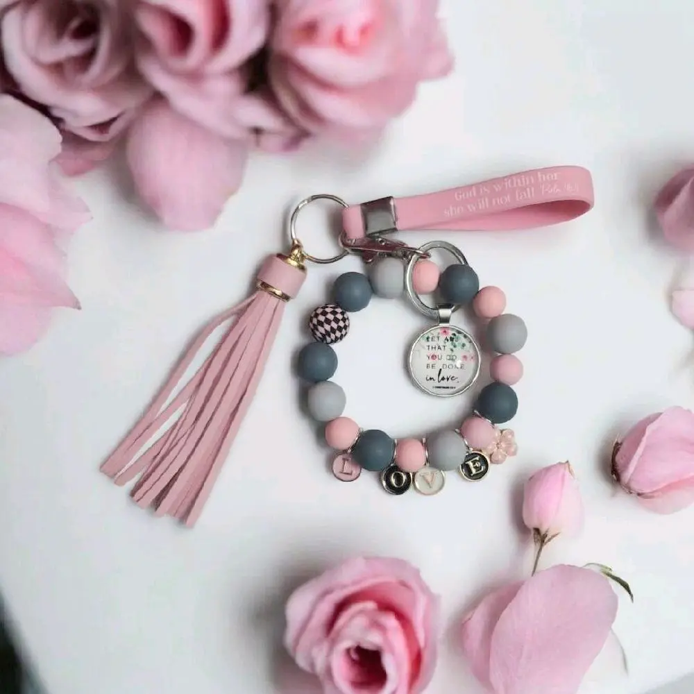 Let all that you do be with love keychain baraclete in pink