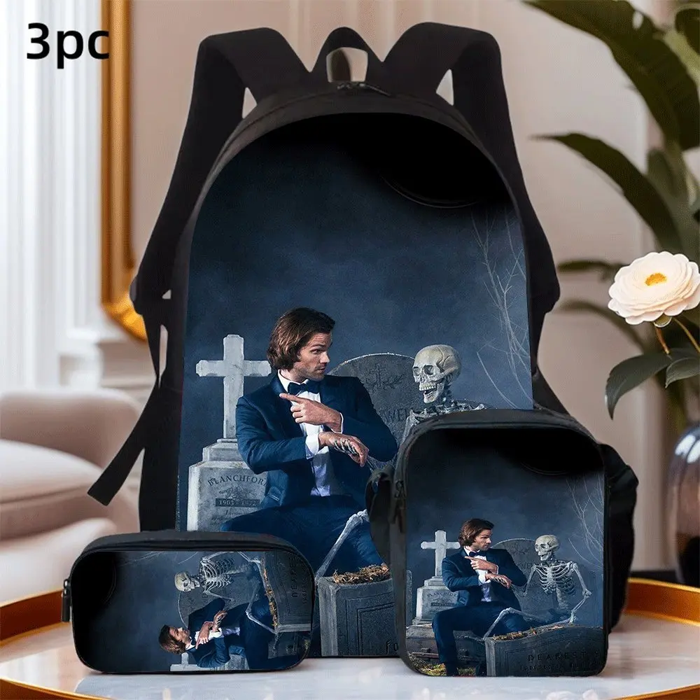 Sling on this backpack set and embark on your adventure!⚰️💀✅ Backpack: Featuring Sam Winchester in formal navy suit posing beside tombstone and sitting skeleton, misty dark graveyard backdrop, classic Supernatural gothic horror artwork, crafted from wea