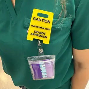 Caution Overstimulated badge reel - Yellow Sign with Black Text, Warning Message for Safety Awareness Outdoor Settings Alert