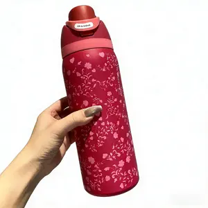 Owala Freesip insulated cup with a red body featuring pastel floral patterns, with a capacity of 32 ounces. It features a one-button pop-up lid and an inbuilt straw.