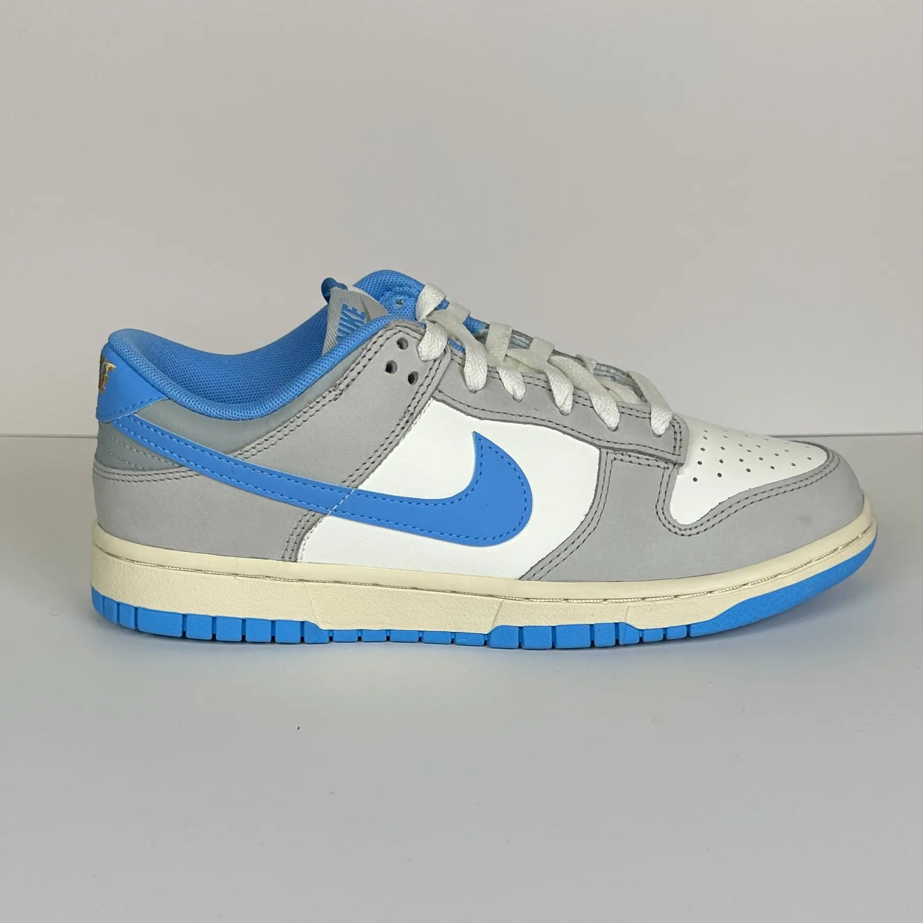 Pre-Owned Nike Dunk Low FN7488-133 Athletic Department University Blue Leather Sneaker - Padded Collar, Iconic Low-Cut Design, Ideal for Sports & Everyday Wear